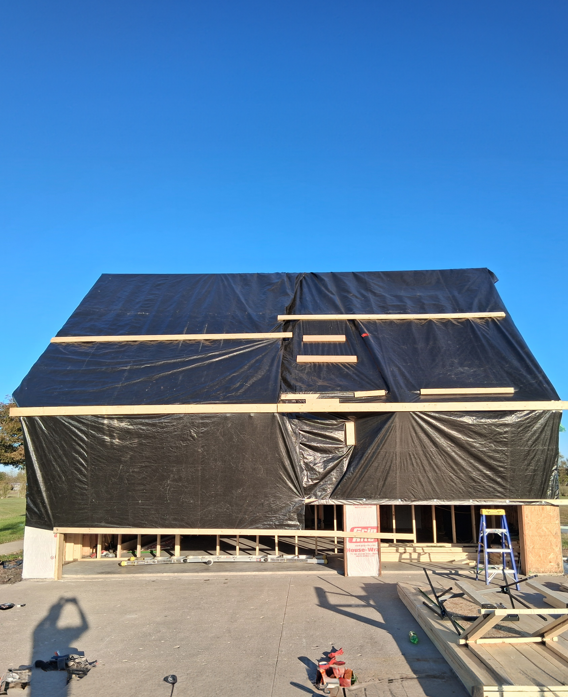 Inside of a roof structure damaged by fire, charred wood and exposed beams.