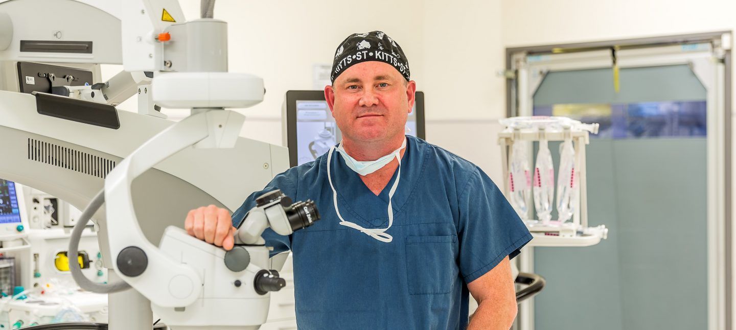 A Surgeon Is Standing In Front Of A Microscope In An Operating Room — CQ Eye In Berserker, QLD