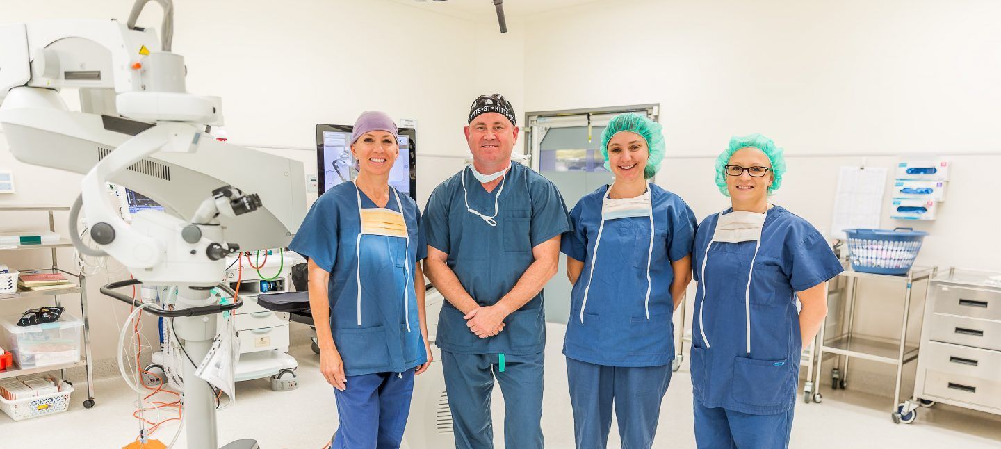 A Group Of Surgeons Are Posing For A Picture In An Operating Room — CQ Eye In Berserker, QLD