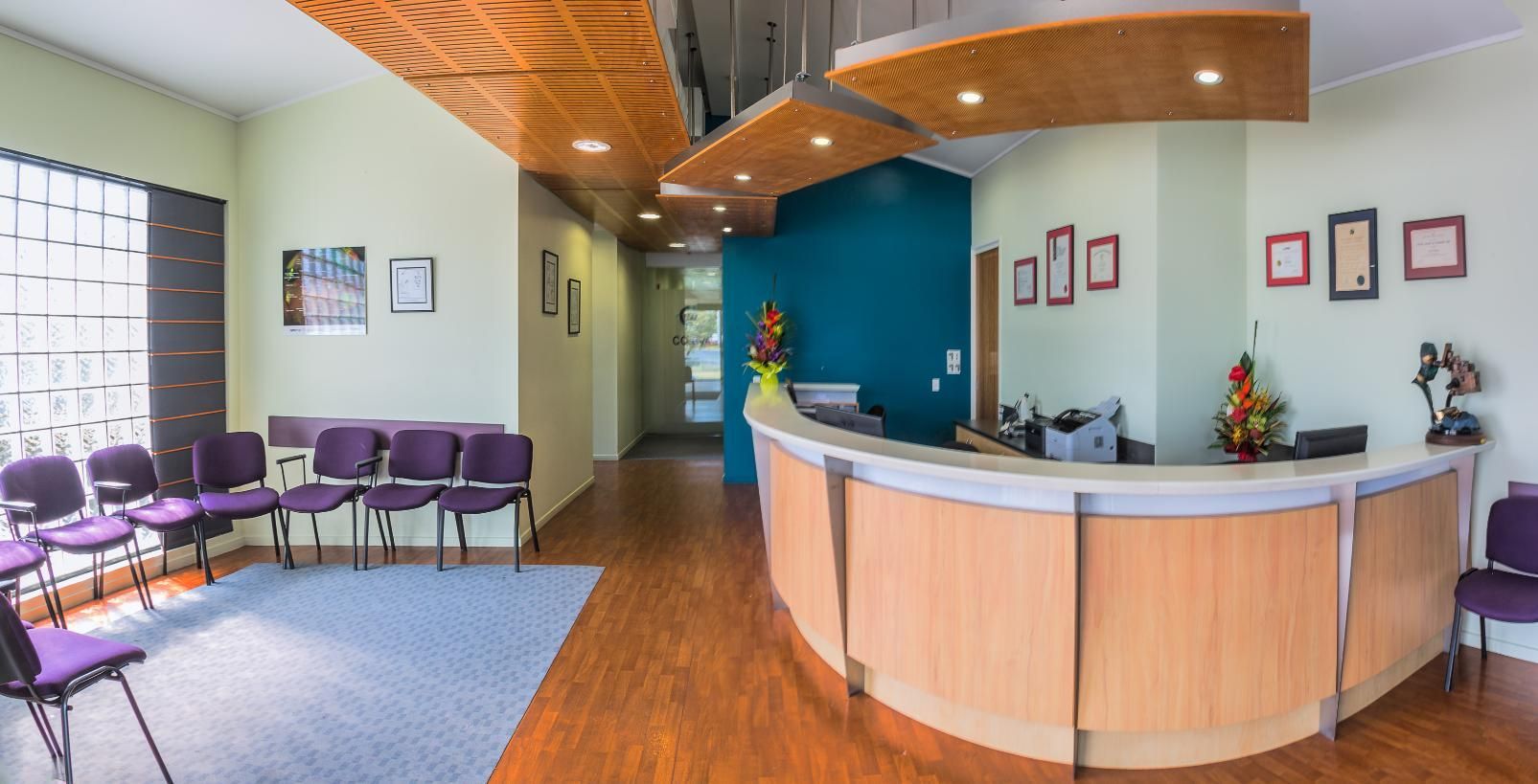 A Waiting Room With A Curved Counter And Purple Chairs — CQ Eye In Berserker, QLD
