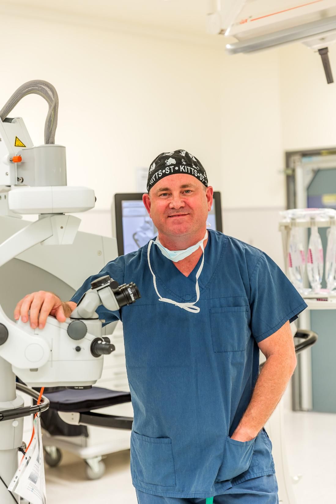 A Surgeon Is Standing In An Operating Room Holding A Microscope — CQ Eye In Berserker, QLD