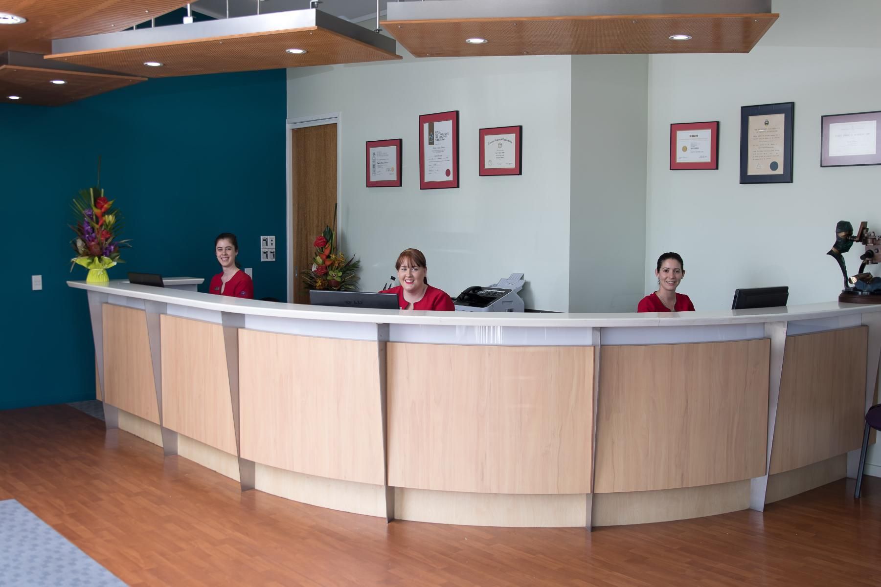Two Women Are Sitting At A Reception Desk In A Hospital — CQ Eye In Berserker, QLD