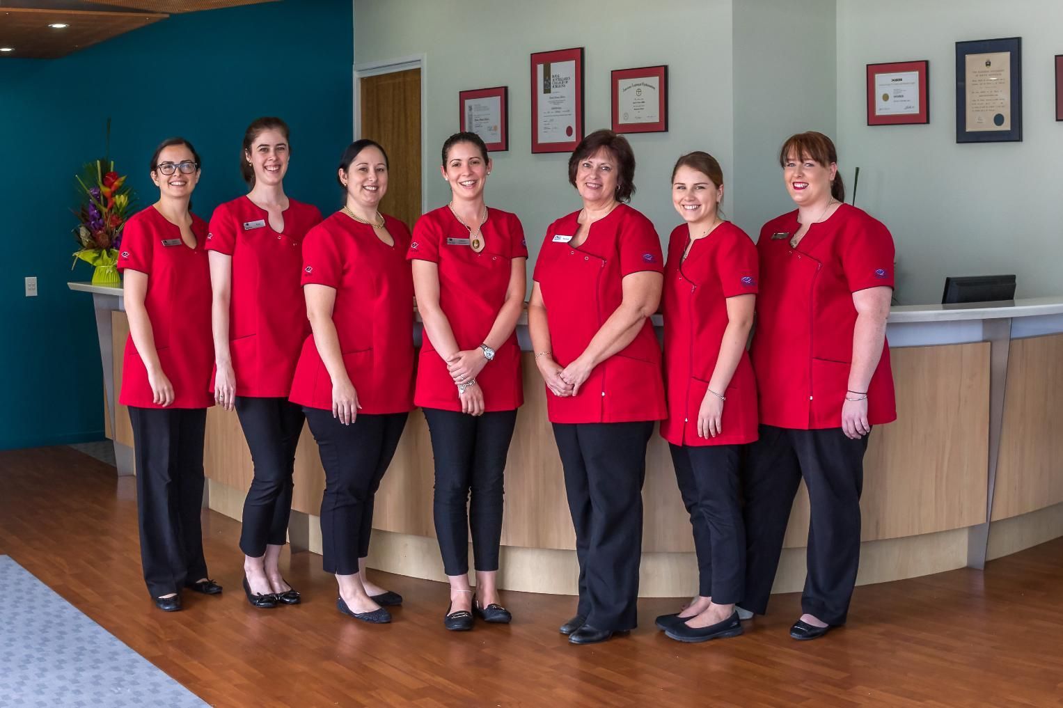 A Group Of Women In Red Uniforms Are Posing For A Picture — CQ Eye In Berserker, QLD