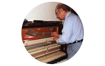 man-fixing-piano