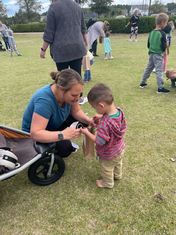 Kid Receiving Gift — Jacksonville, FL — Moonbow Childcare