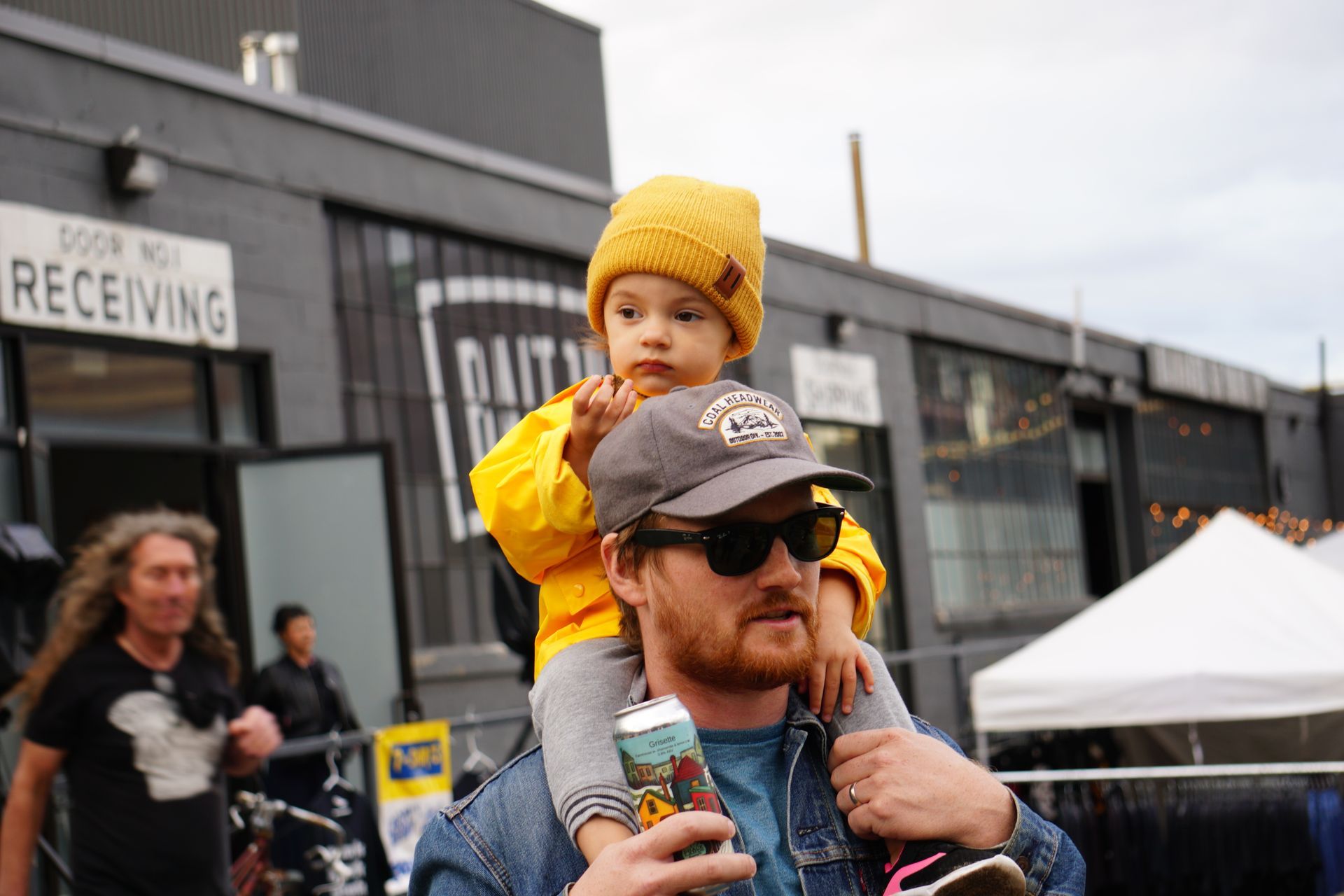 A man is holding a baby upside down in his arms