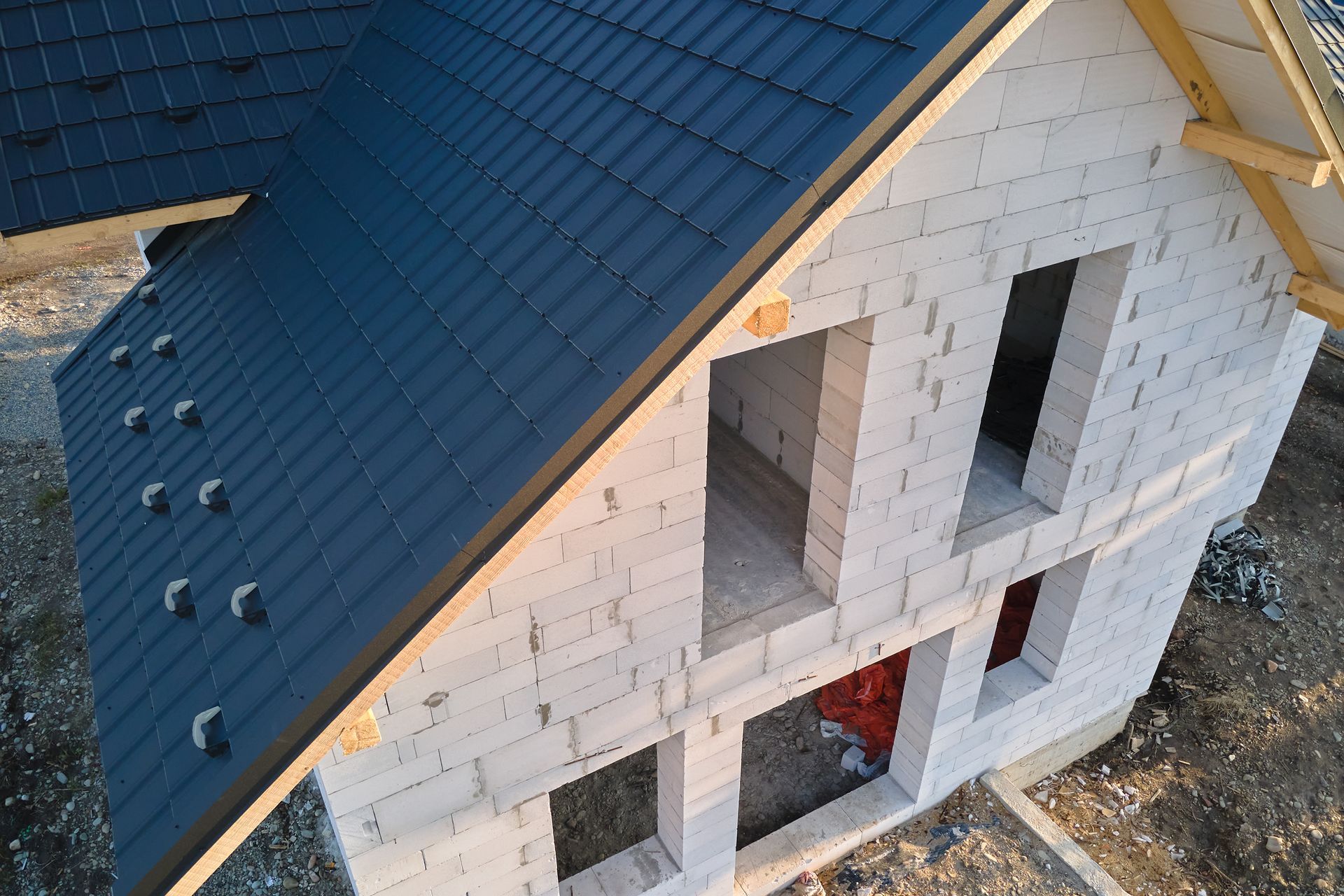 an aerial view of a house under construction with a blue roof