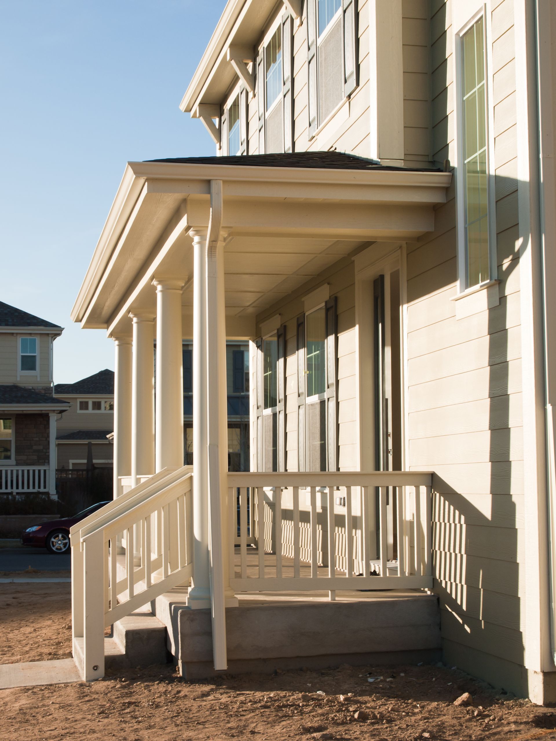 a white house with a porch and stairs