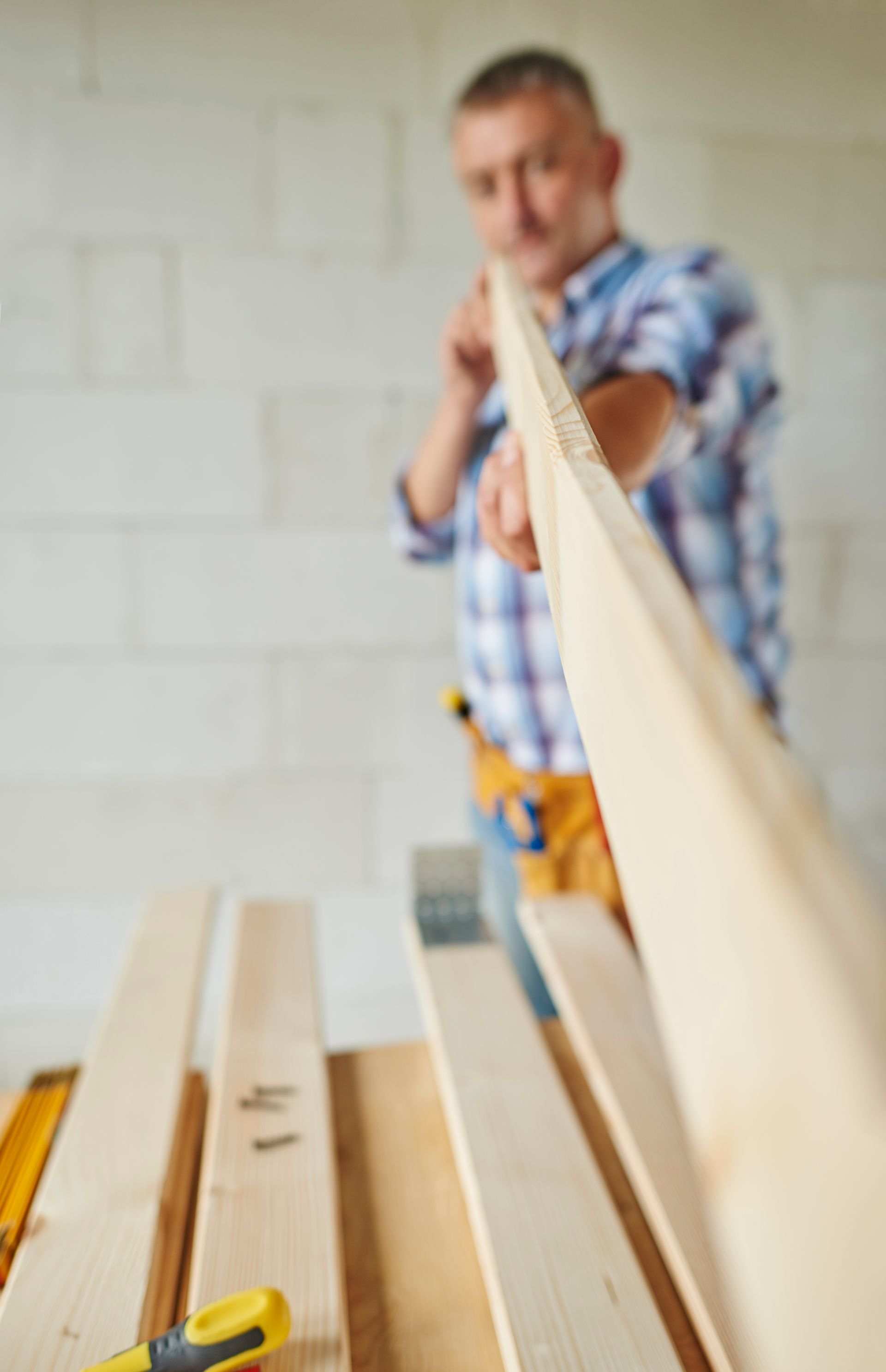 a man is holding a piece of wood in his hand .