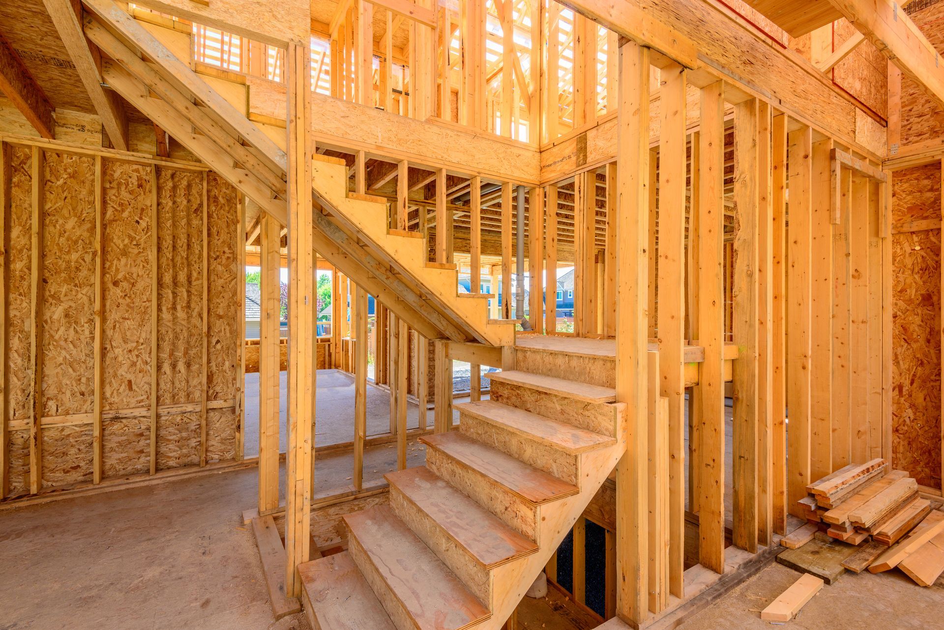a wooden staircase is being built in a house under construction .
