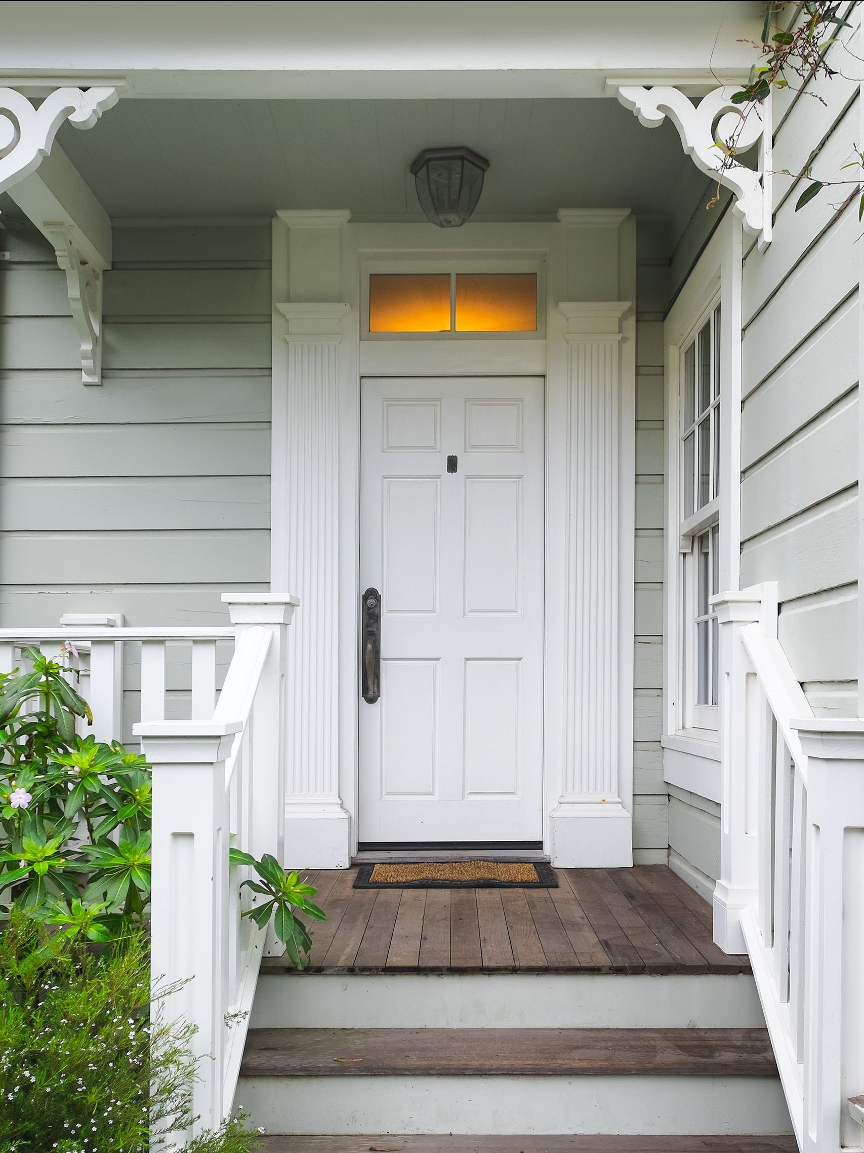 a white house with a white door and stairs