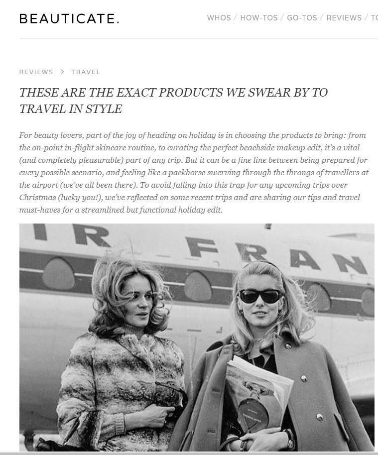 Two women in vintage attire, in front of a plane, advertising travel beauty products.