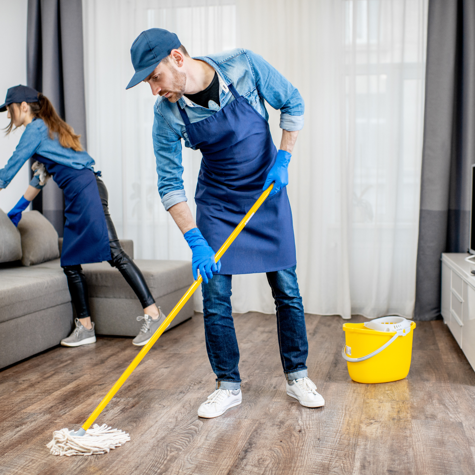 A group of people are cleaning a kitchen counter.