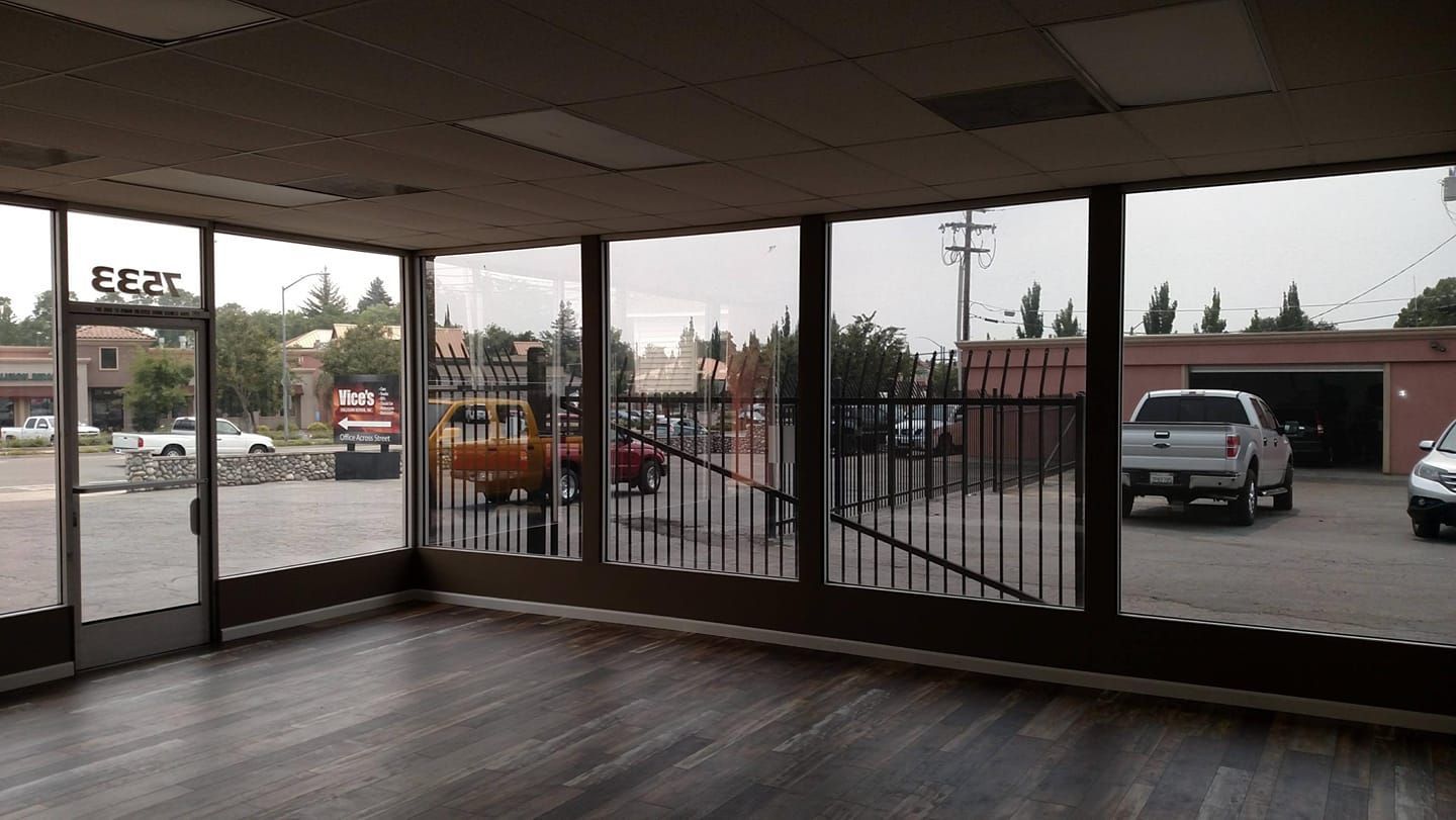 Black Hyundai Santa Cruz pickup truck parked outside a building with red trim.