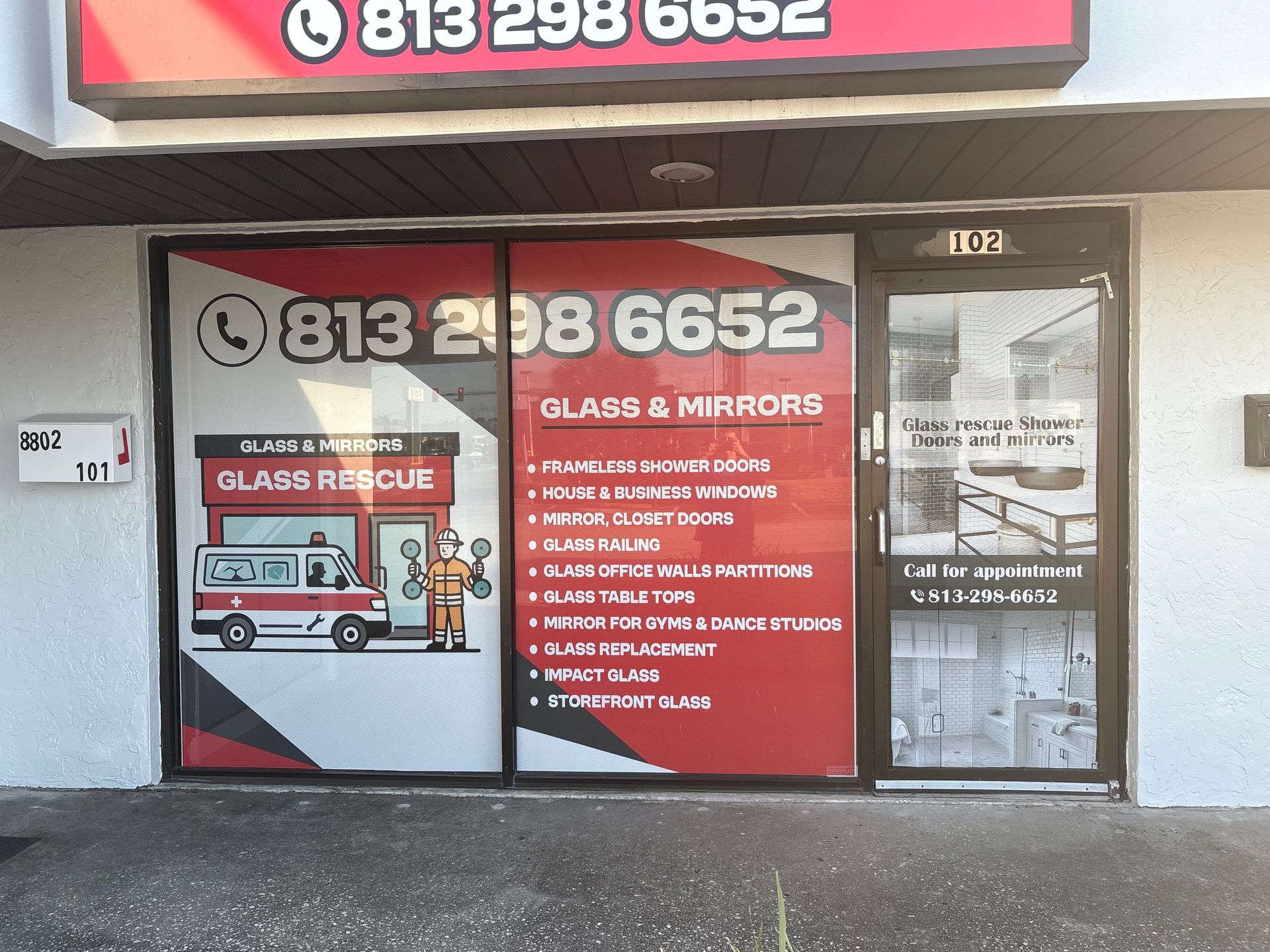 Storefront with large window advertising glass repair services and phone number 813-298-6652.