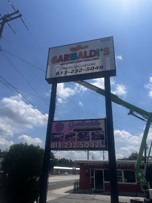 Sign for Garibaldi's Mexican Cuisine with a lower sign; a work lift is visible.