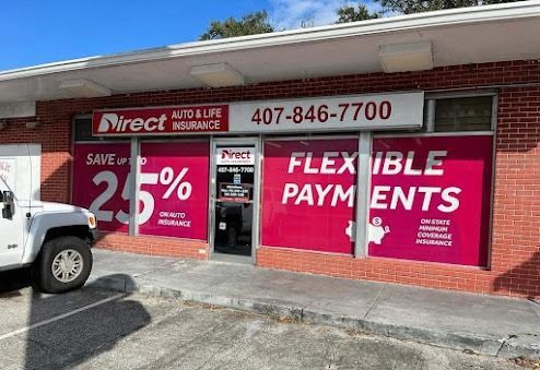 Direct Auto & Life Insurance storefront with bright pink window graphics. A white Jeep is parked nearby.