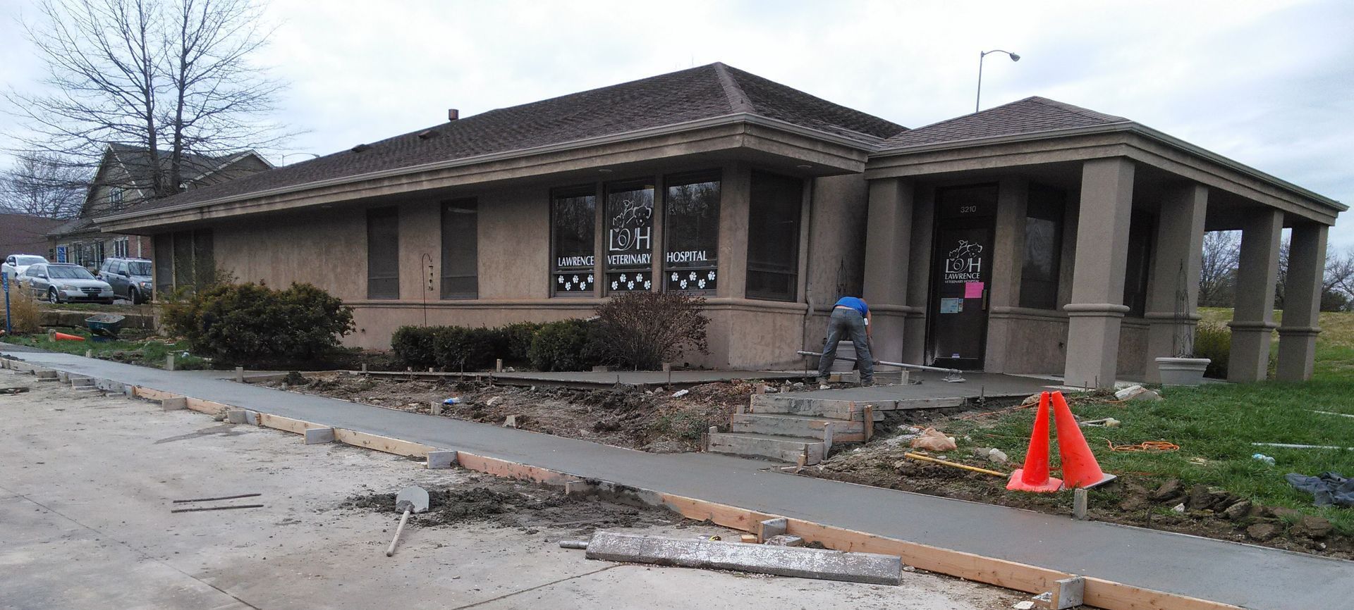 A house with a concrete walkway in front of it
