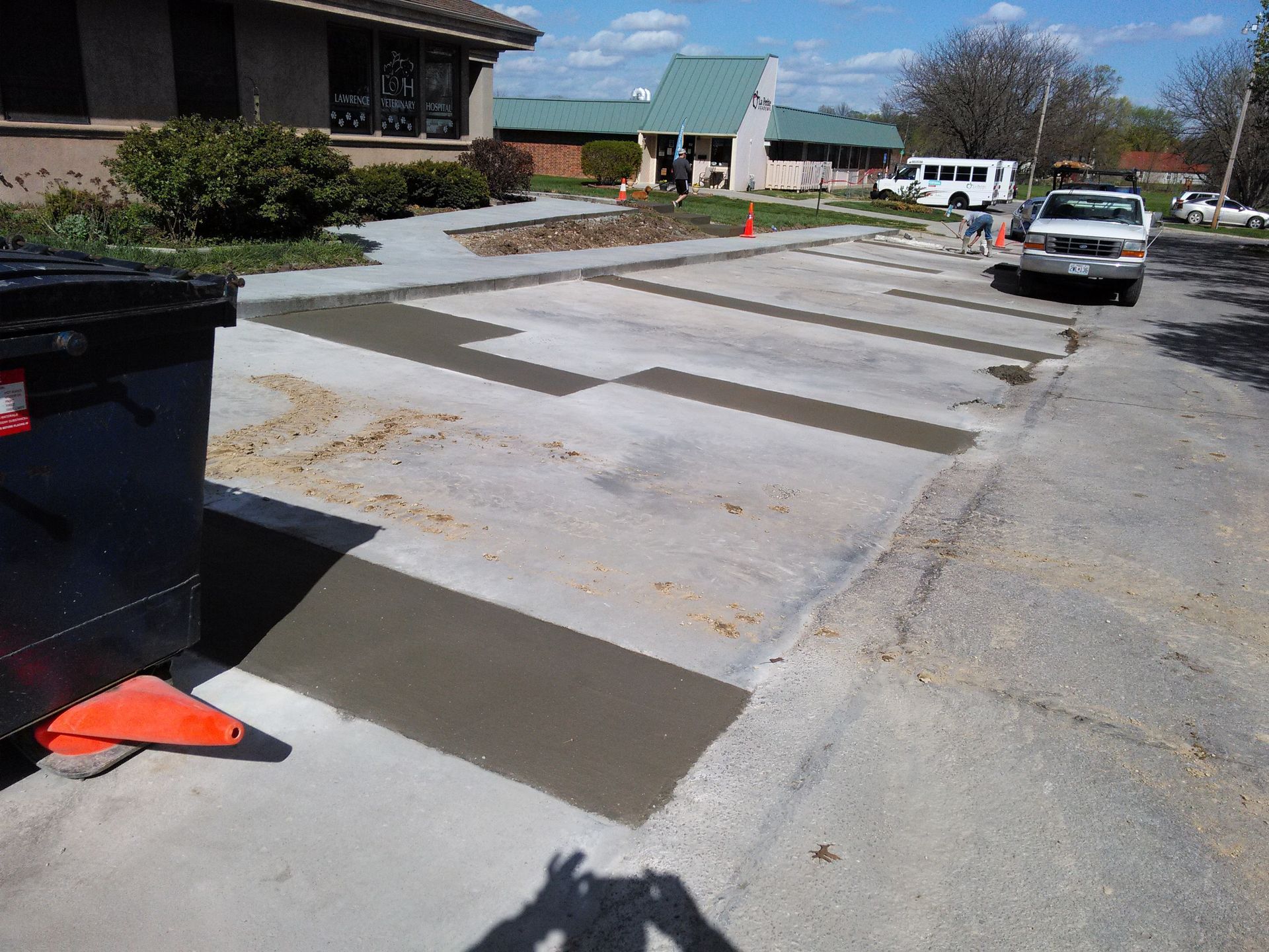 A shadow of a person is cast on a concrete surface