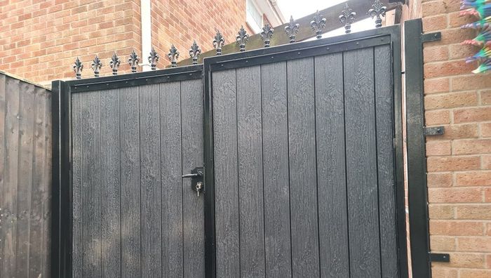 Composite Gates UK pair of composite driveway gates with fleur de lis toppers