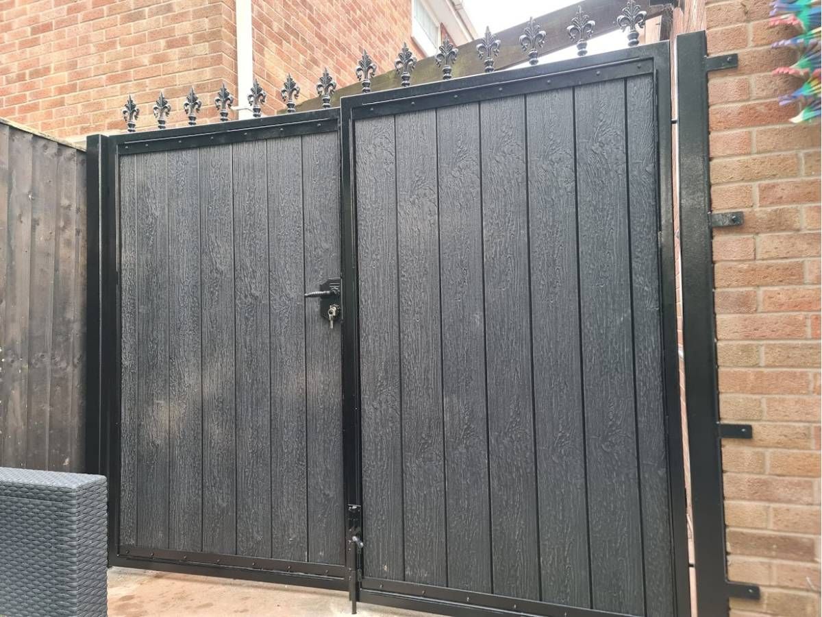 Composite driveway gates with fleur de lis finials