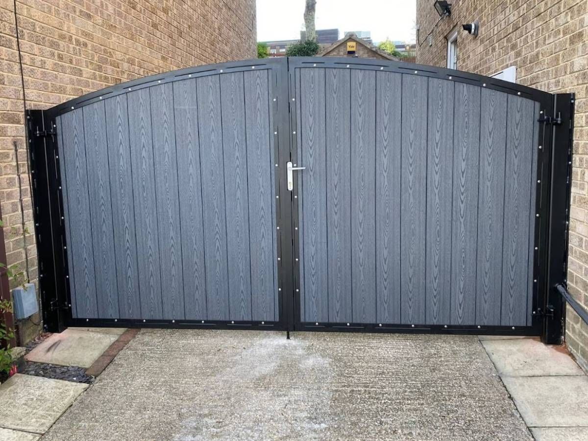 Hinged grey arched composite driveway gates in Melton Mowbray