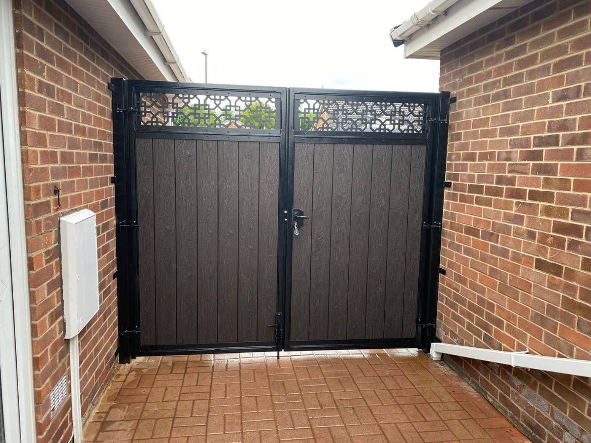 Chocolate composite driveway gates with trellis topper installed in
Colchester