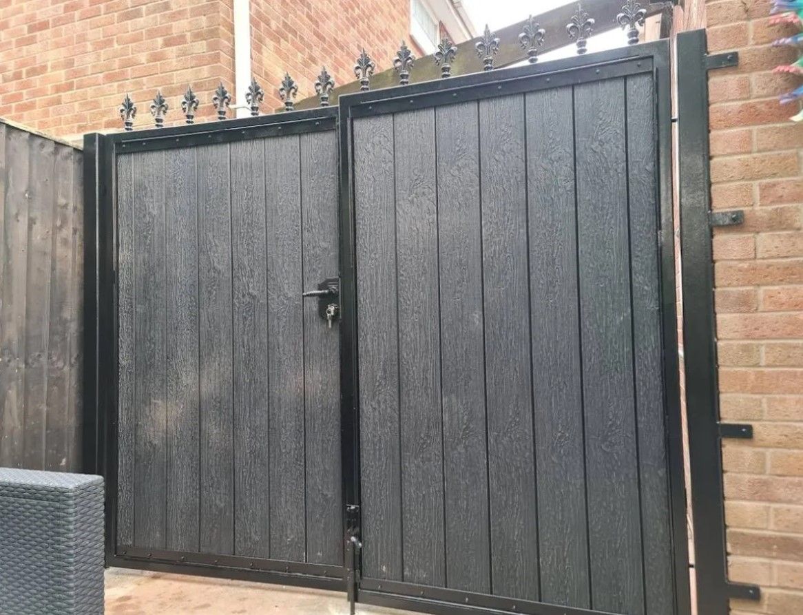 Composite driveway gates with fleur de lis finials in Portslade