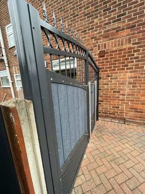 Arched silver grey composite gates fixed to existing concrete post 