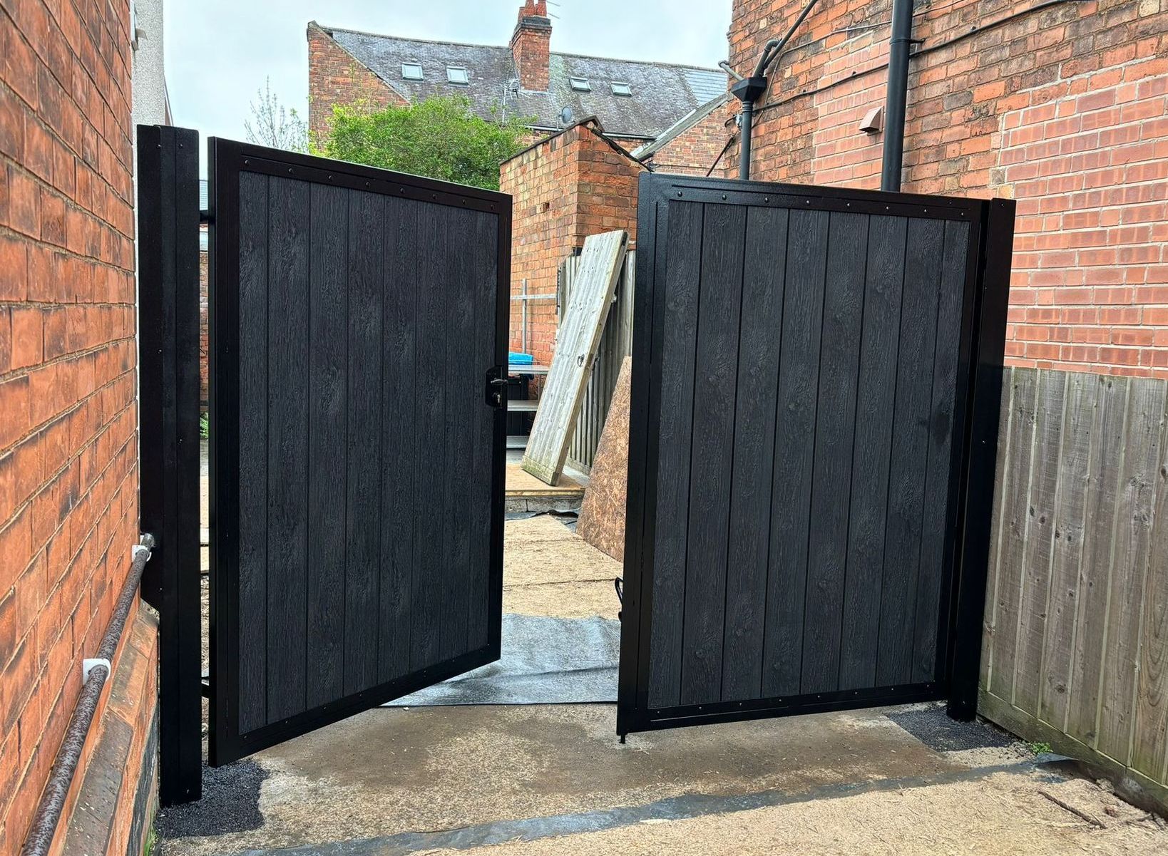 Double 6 foot grey composite driveway gates opened