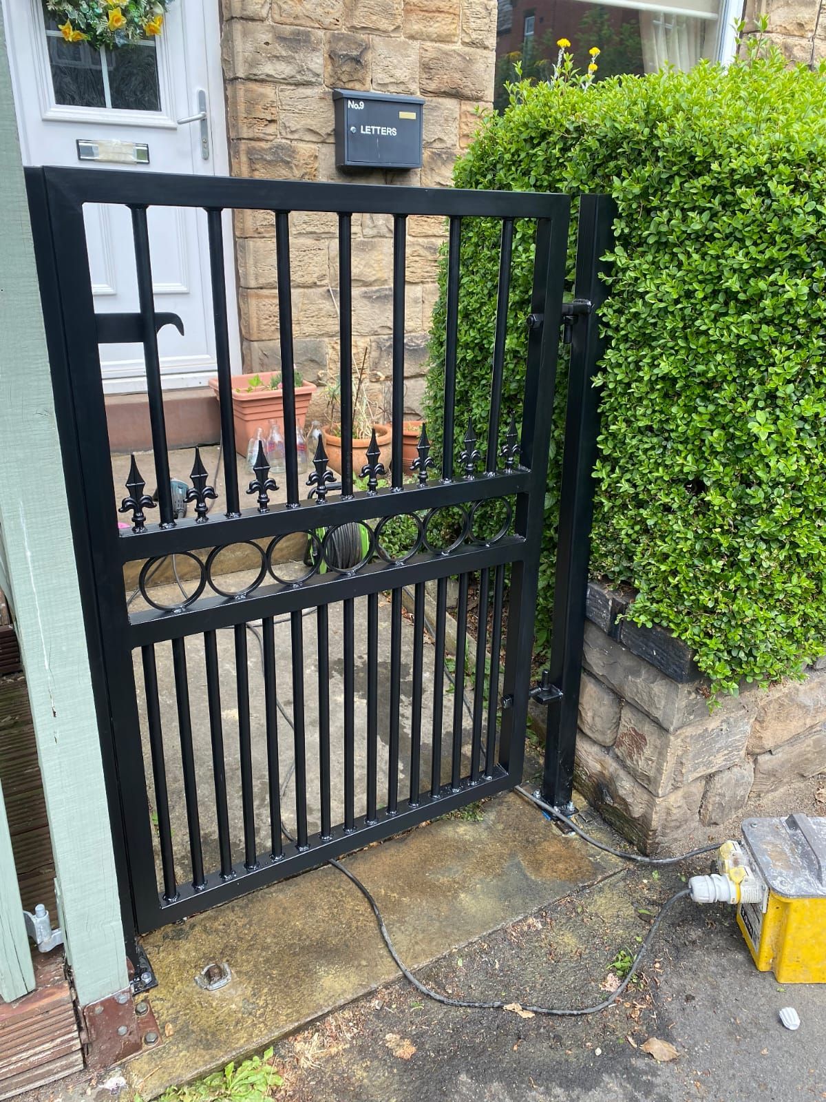 Composite Gates UK front garden metal gate with rings and fleur de lis