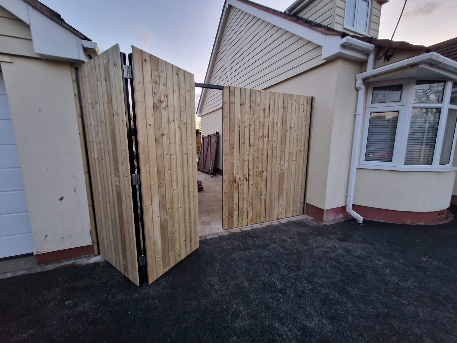 Composite Gates UK metal framed wooden bi-fold gates partially opened