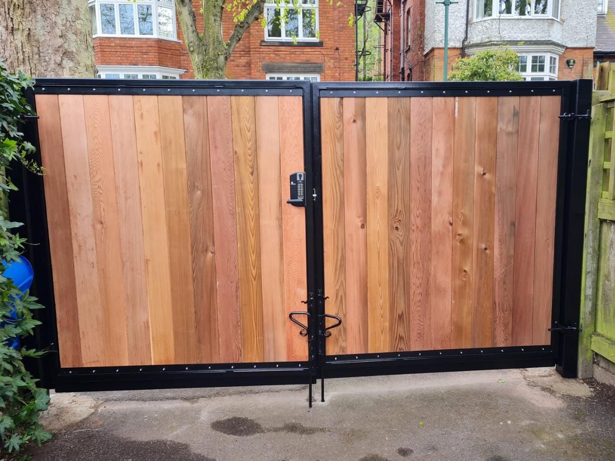 Composite Gates UK outside view of metal framed wooden driveway gates with keypad lock