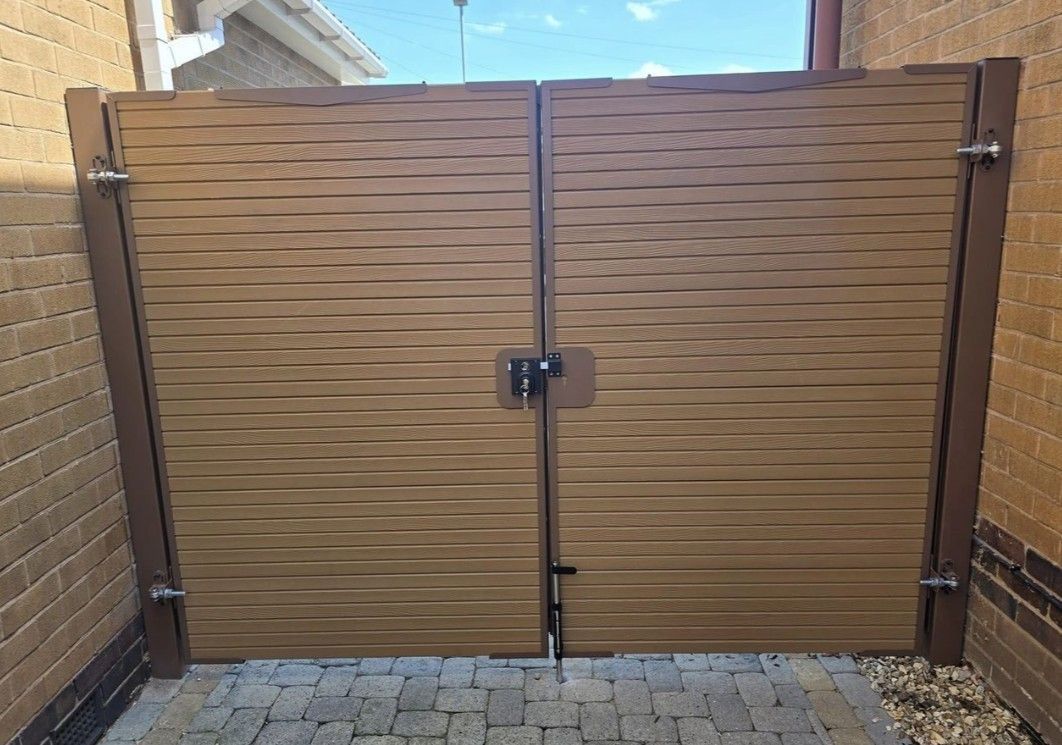 Two colour composite driveway gates with trellis topper installed in 
Blackpool