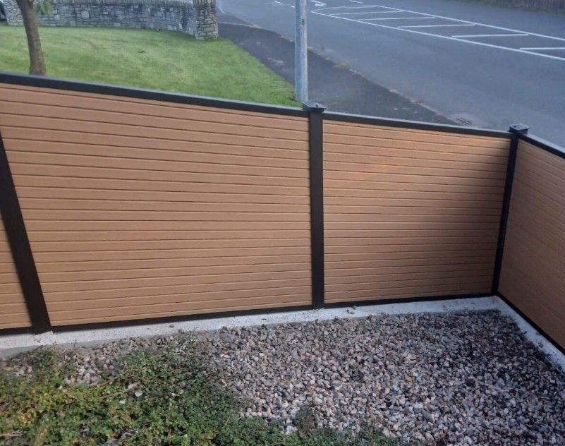 Composite Gates UK natural timber composite fencing installed in a sloping garden in Preston