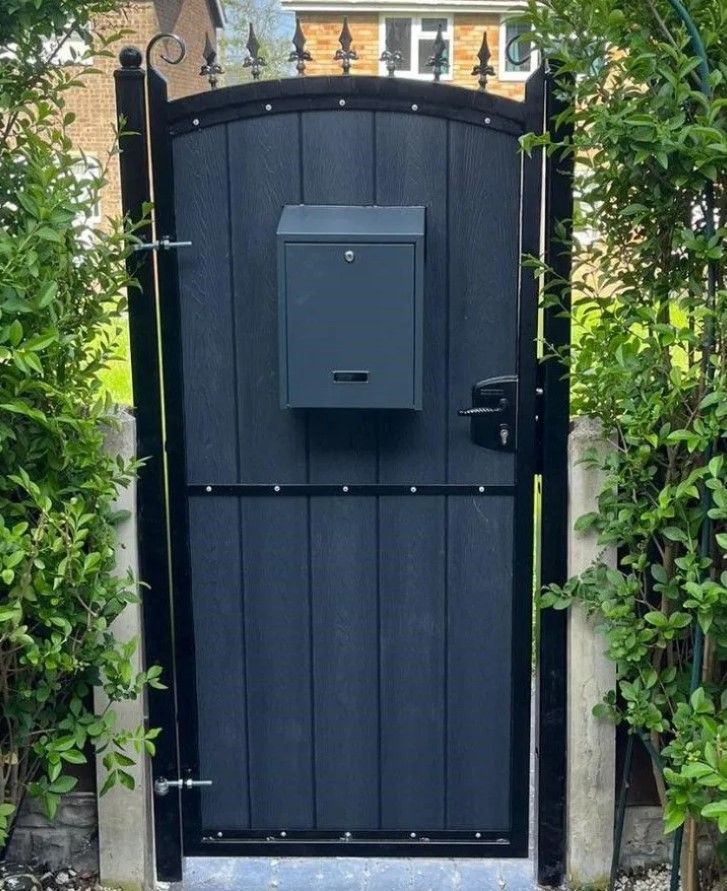 Arched composite pedestrian gate with fleur de lis finials and letterbox installed