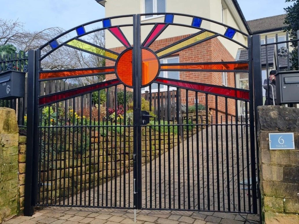 Perspex filled arched metal driveway gates Cirencester