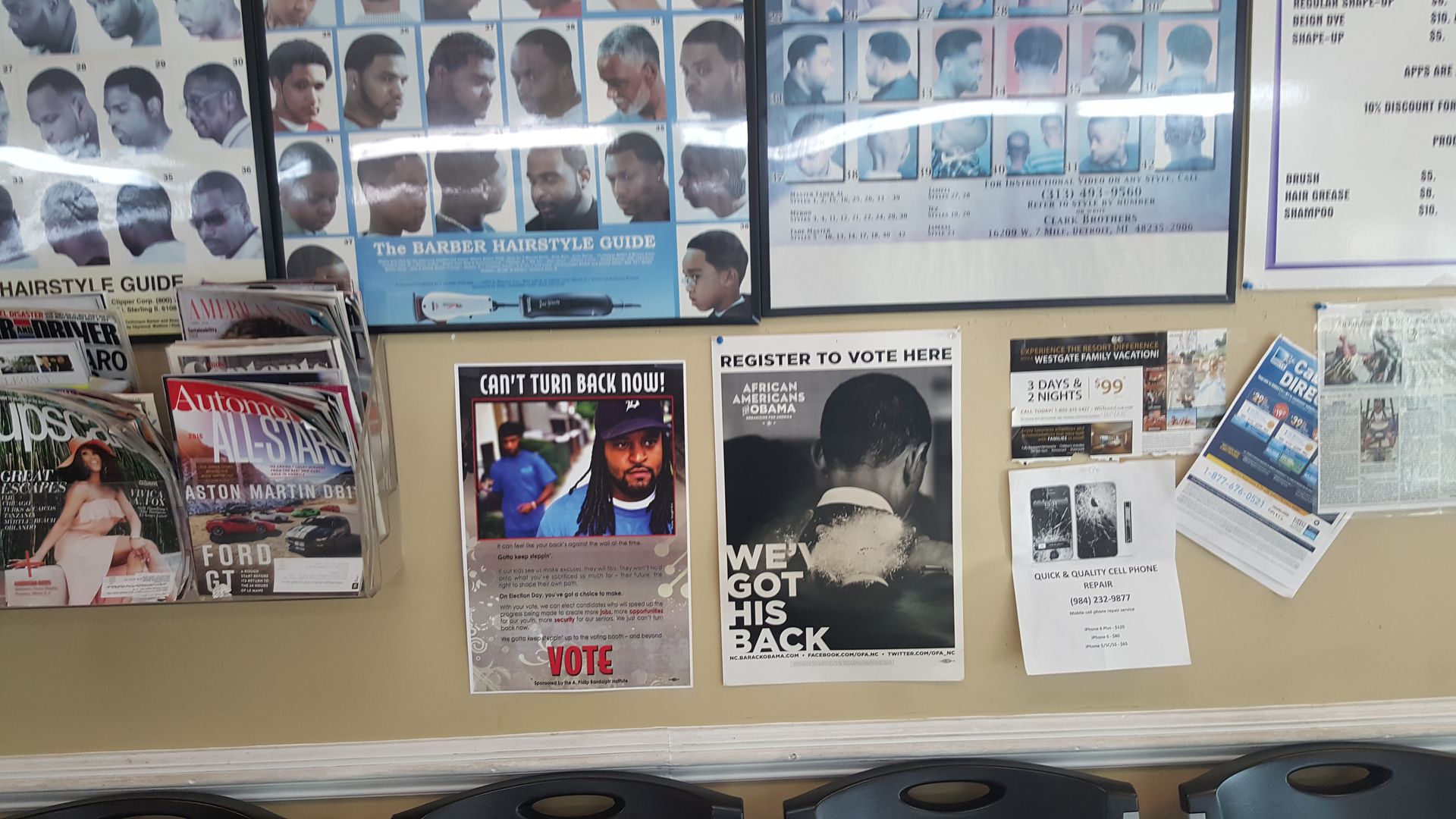 A barber shop with posters on the wall including one that says 