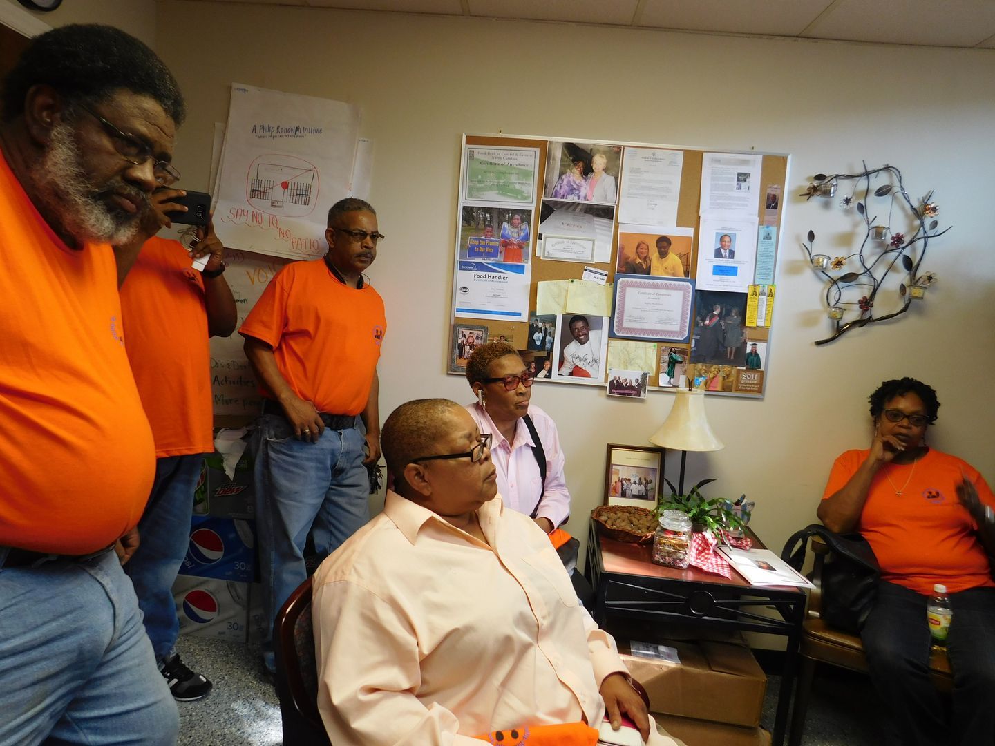 A group of Get Out The Vote volunteers are meeting in a room