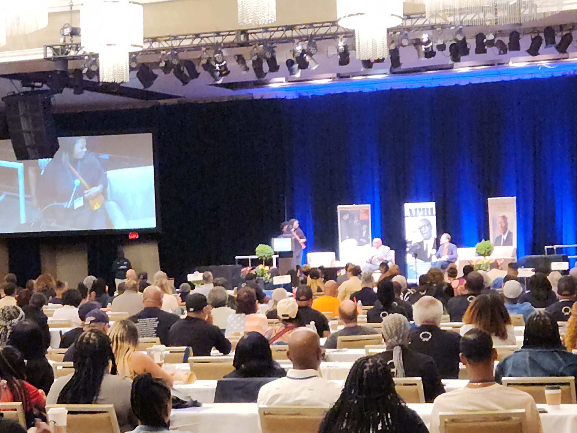 A large group of people are sitting in a conference room at the APRI 52nd National Education Conference