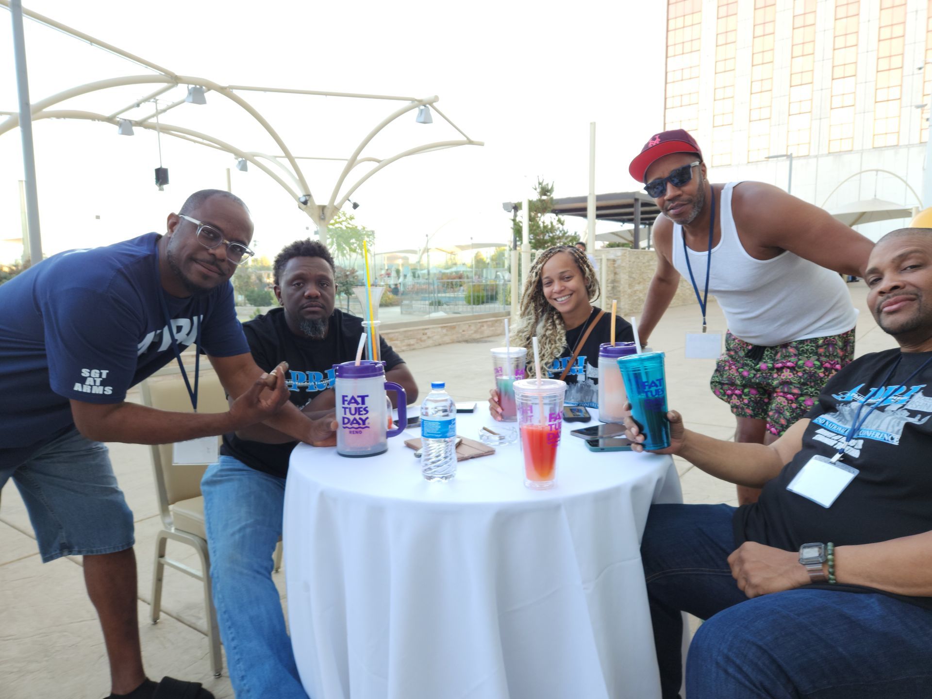 A group of people are sitting around a table with drinks.
