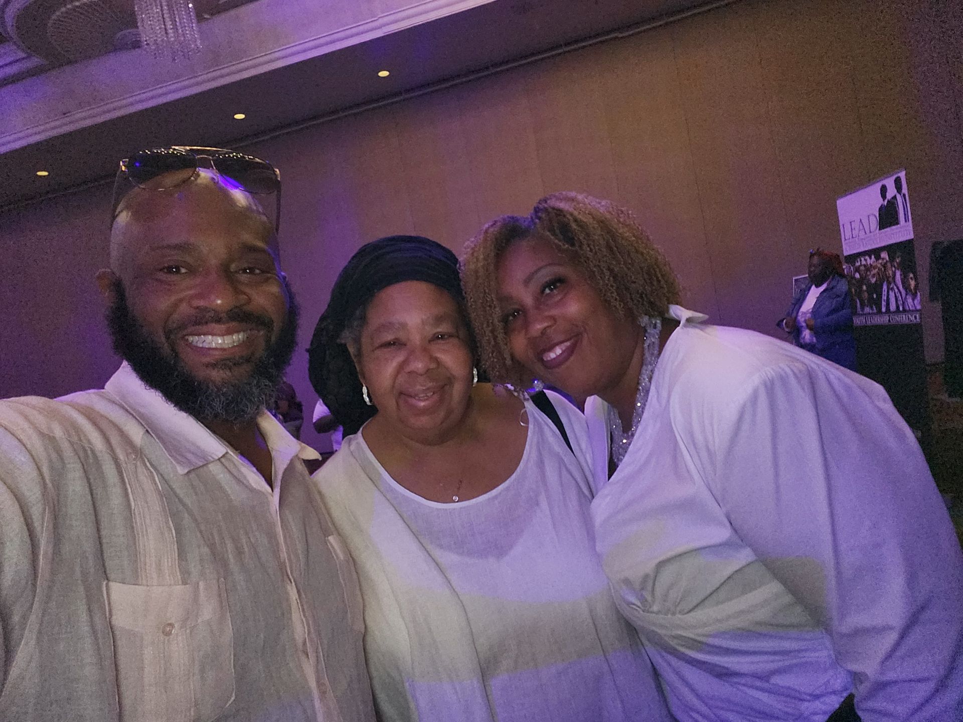 A man and two women are posing for a picture together at an APRI event