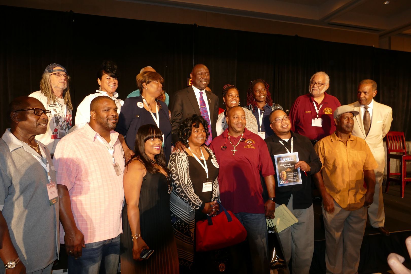 A group of people posing for a picture on a stage  at an APRI event
