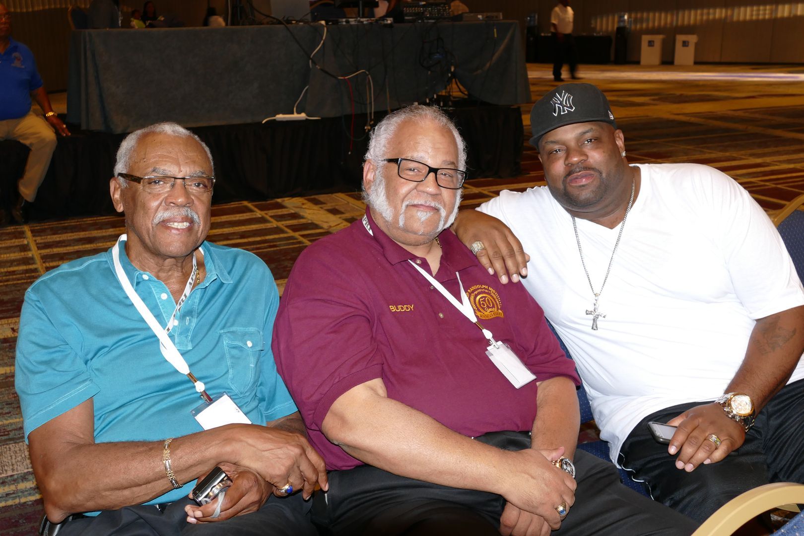 O.G.'s of APRI posing for a picture with a younger one wearing a hat