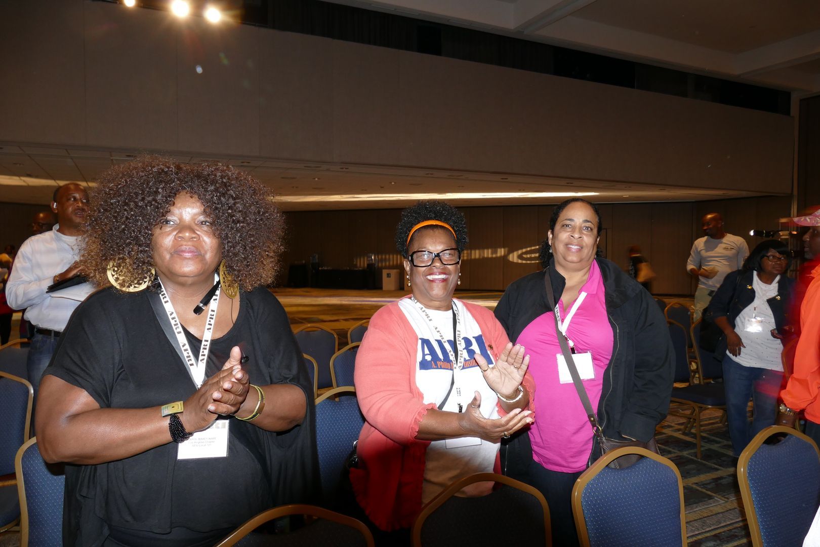 A group of women are standing next to each other in a room  at an APRI event