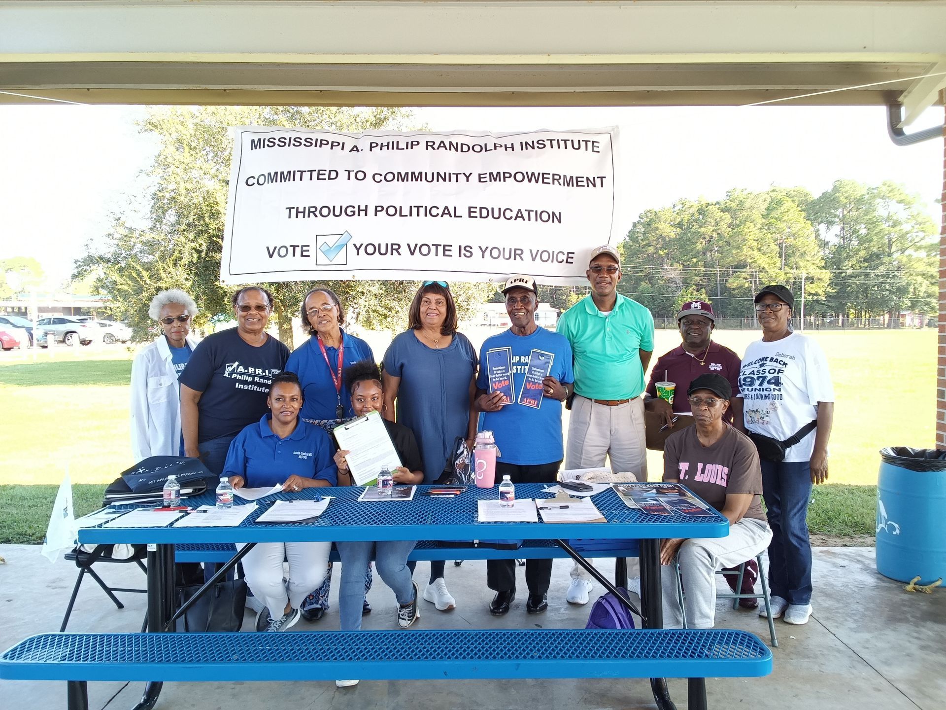 Voter registration volunteers stand for a group photo on a sunny day in Mississippi 