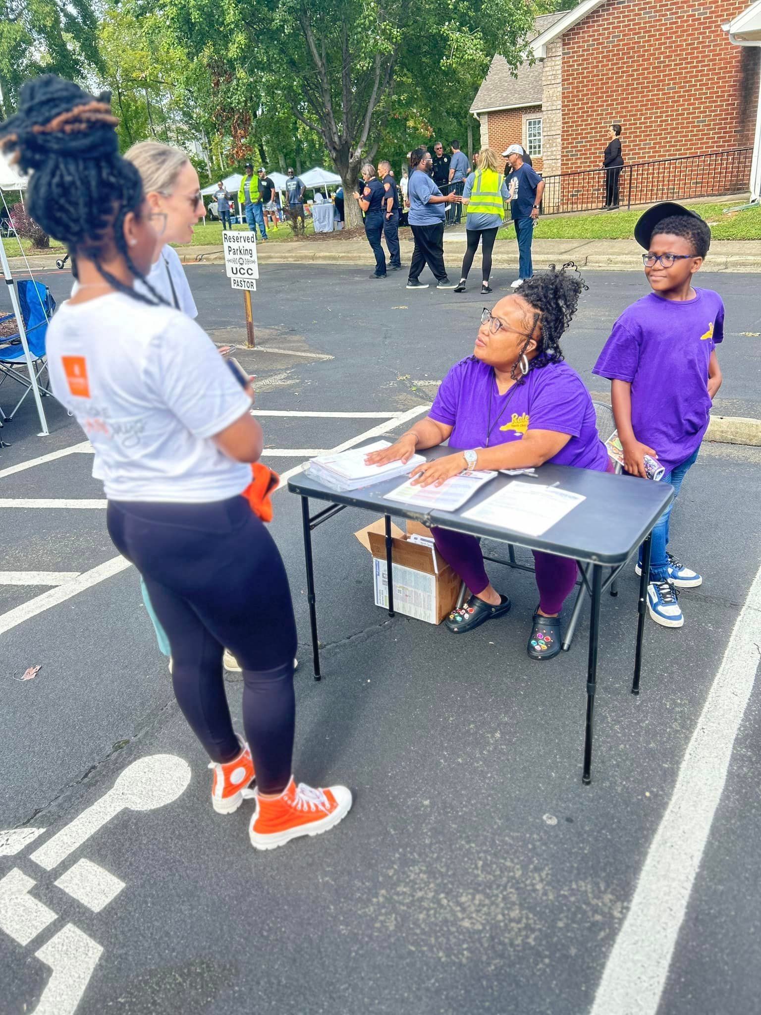 Voter registration volunteers in North Carolina outside at a table
