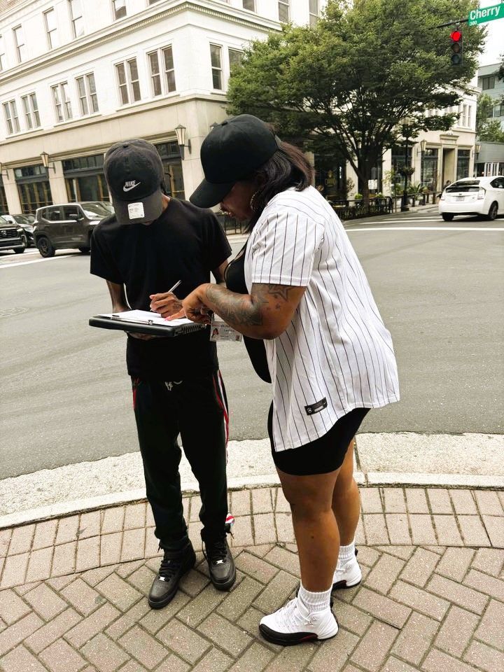 Voter registration volunteer dressed in black registering a citizen in North Carolina