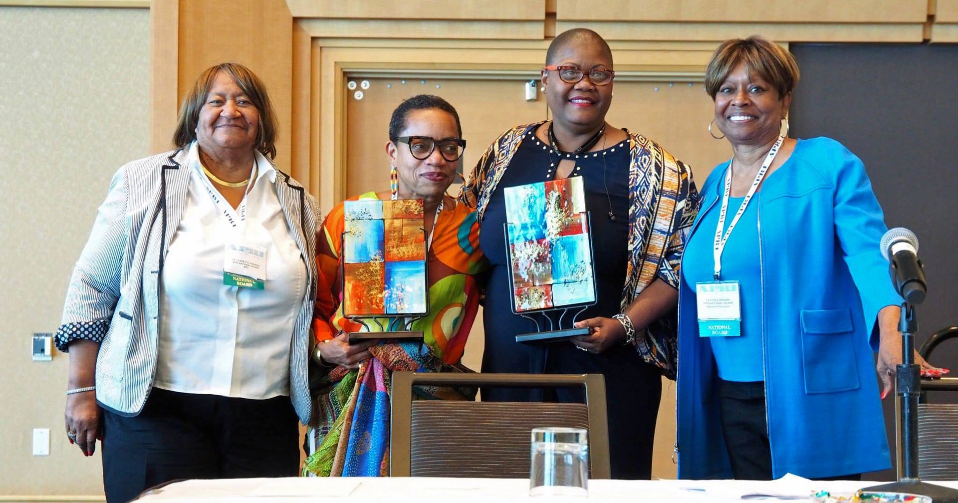 A group of women are posing for a picture at a table.