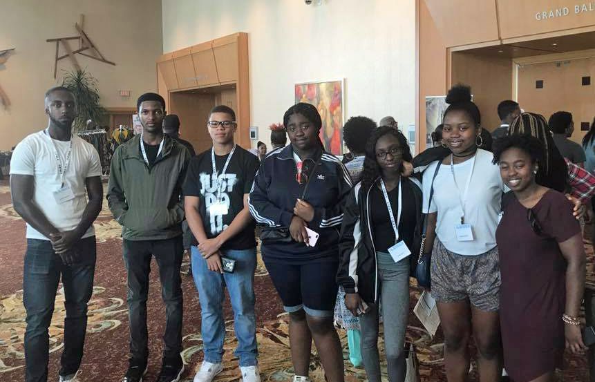 A group of people are posing for a picture in a room.